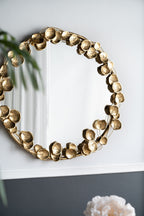 Round Metal Wall Mirror With Leaf Accents in Gold